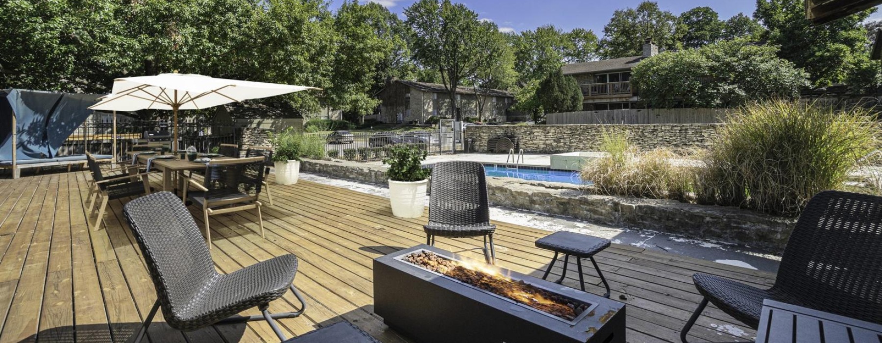 a patio with chairs and tables and a pool