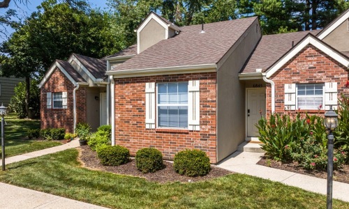 the exterior of a brick building near woods