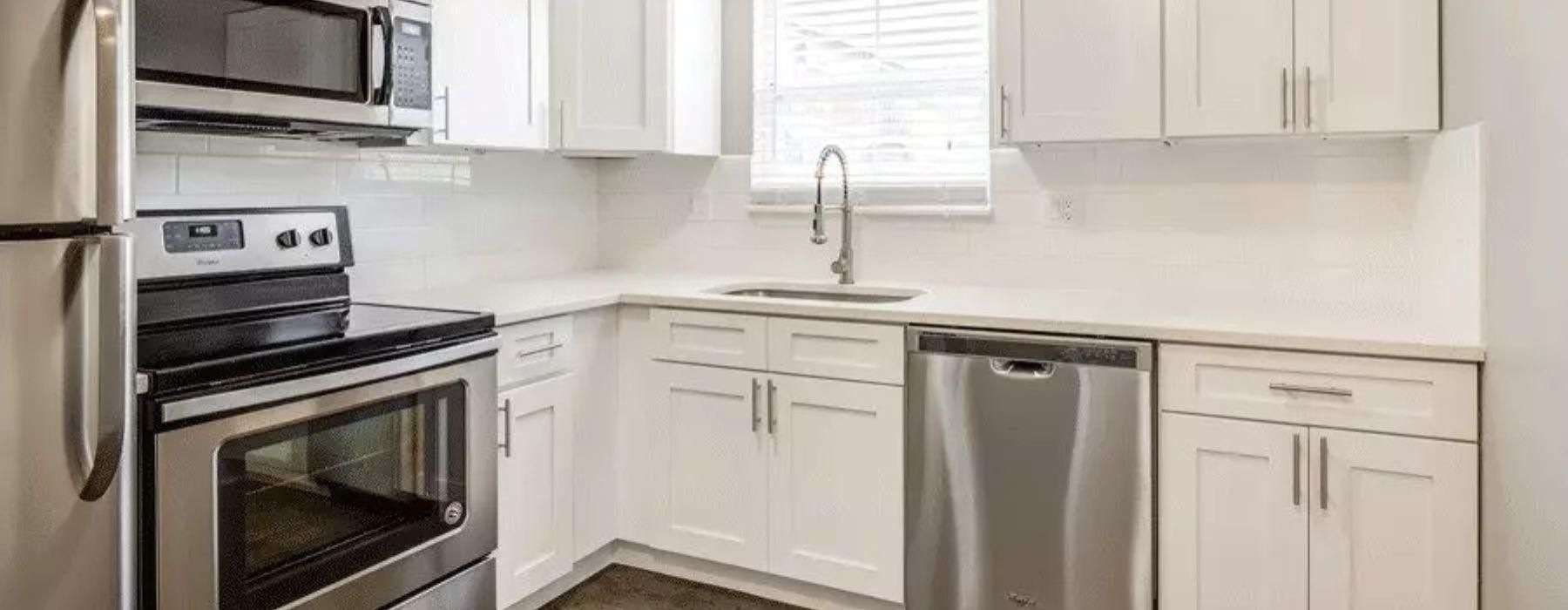 a kitchen with white cabinets