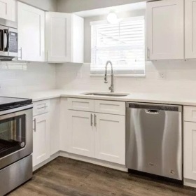 a kitchen with white cabinets